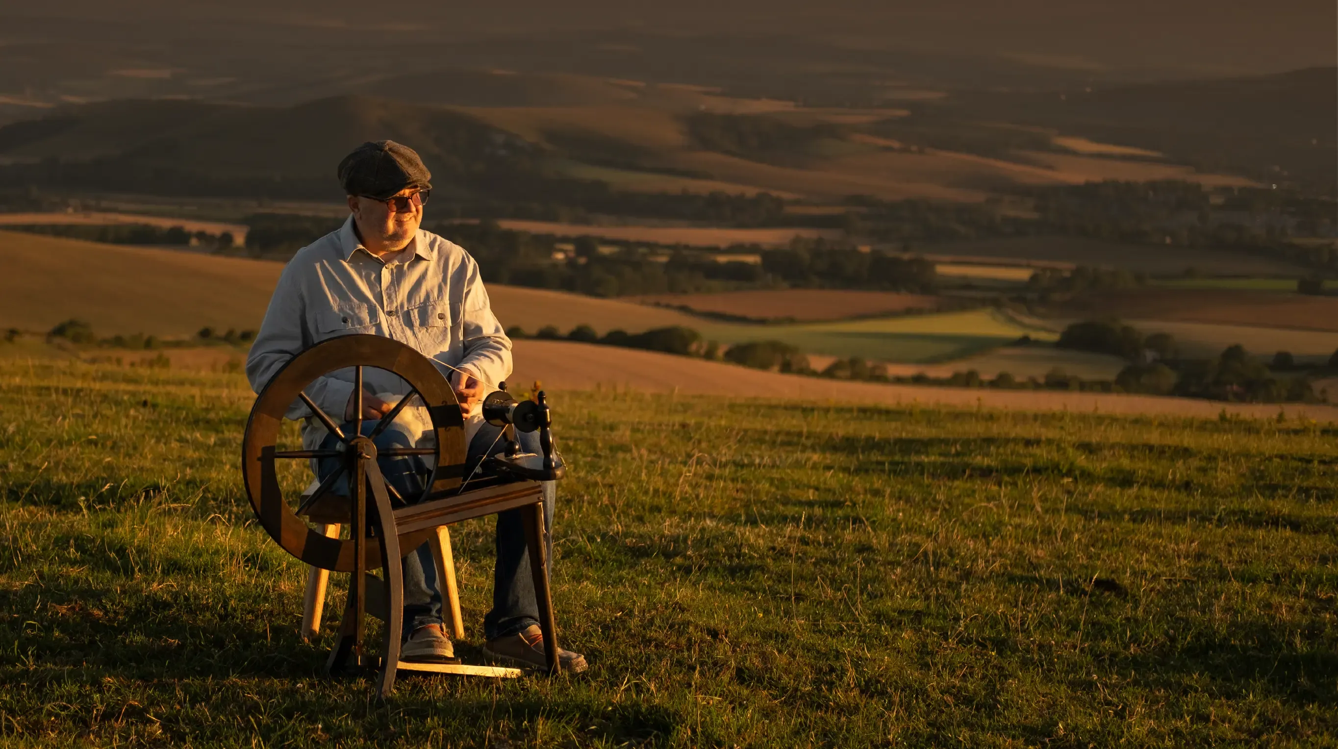 A spinner working outdoors at sunset.